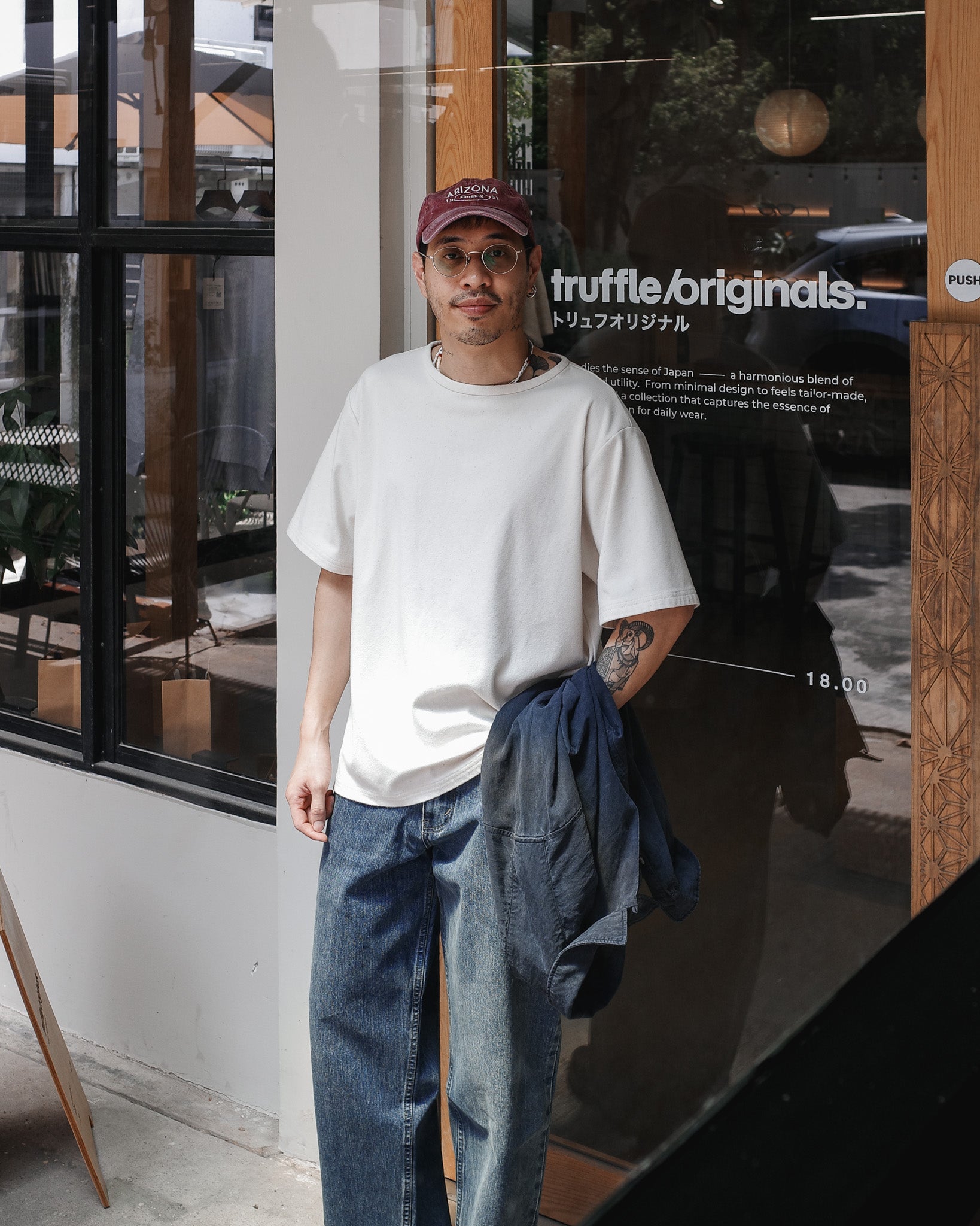  A man wearing a white tee with blue jeans 